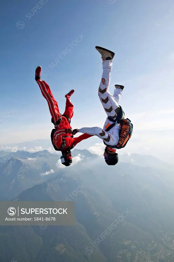 Two skydivers falling in head_down position, Locarno, Tessin, Switzerland