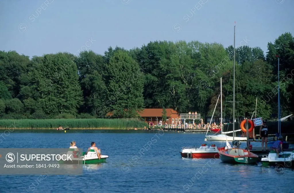 Two people boating in river, Schaalsee, Mecklenburg_Vorpommern, Germany