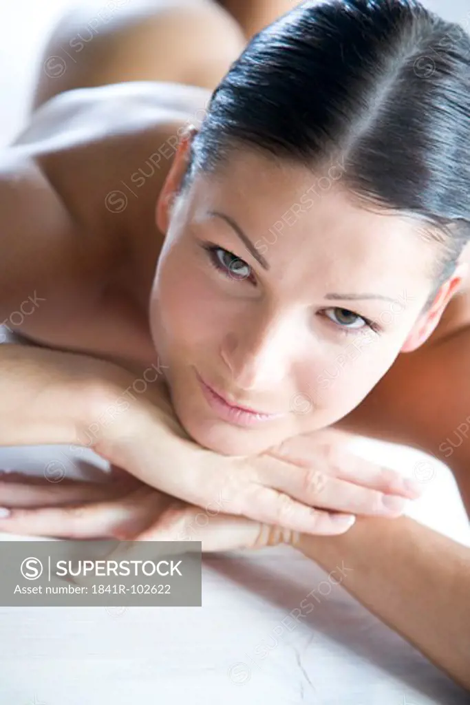 nude woman laying on stomach