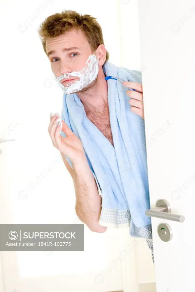 man applying shaving mousse