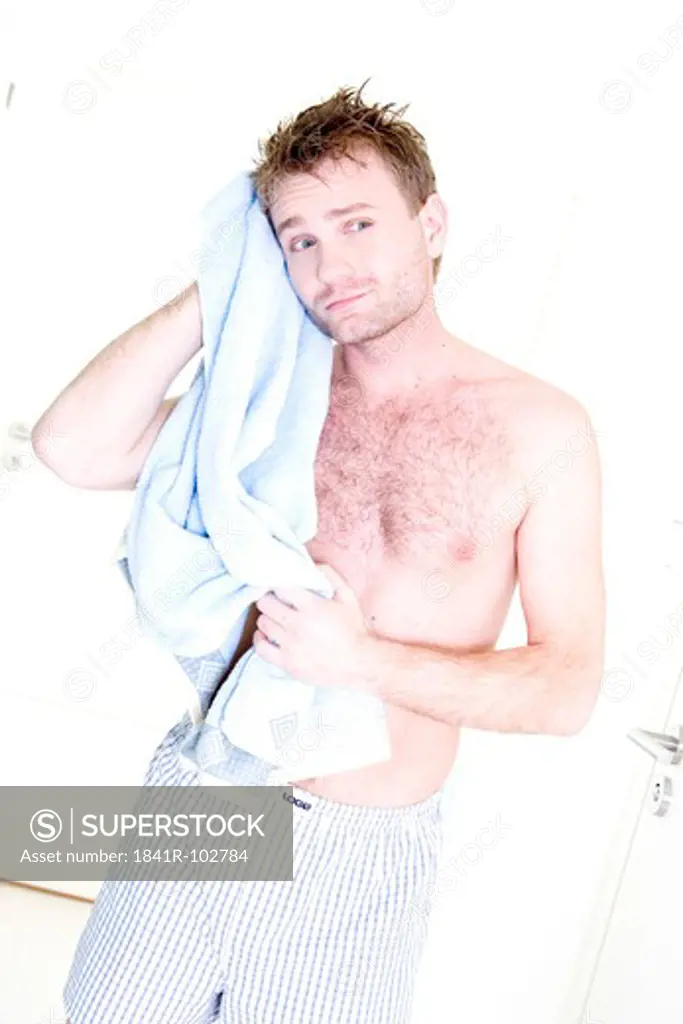 smiling man drying himself with a towel