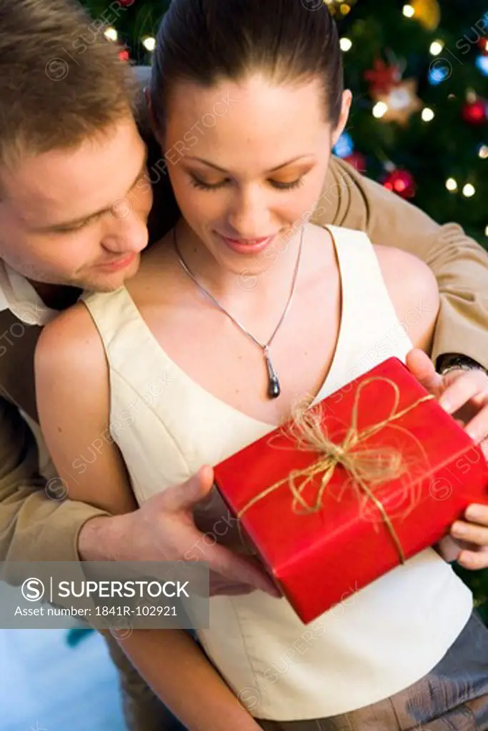 couple giving themself christmas presents