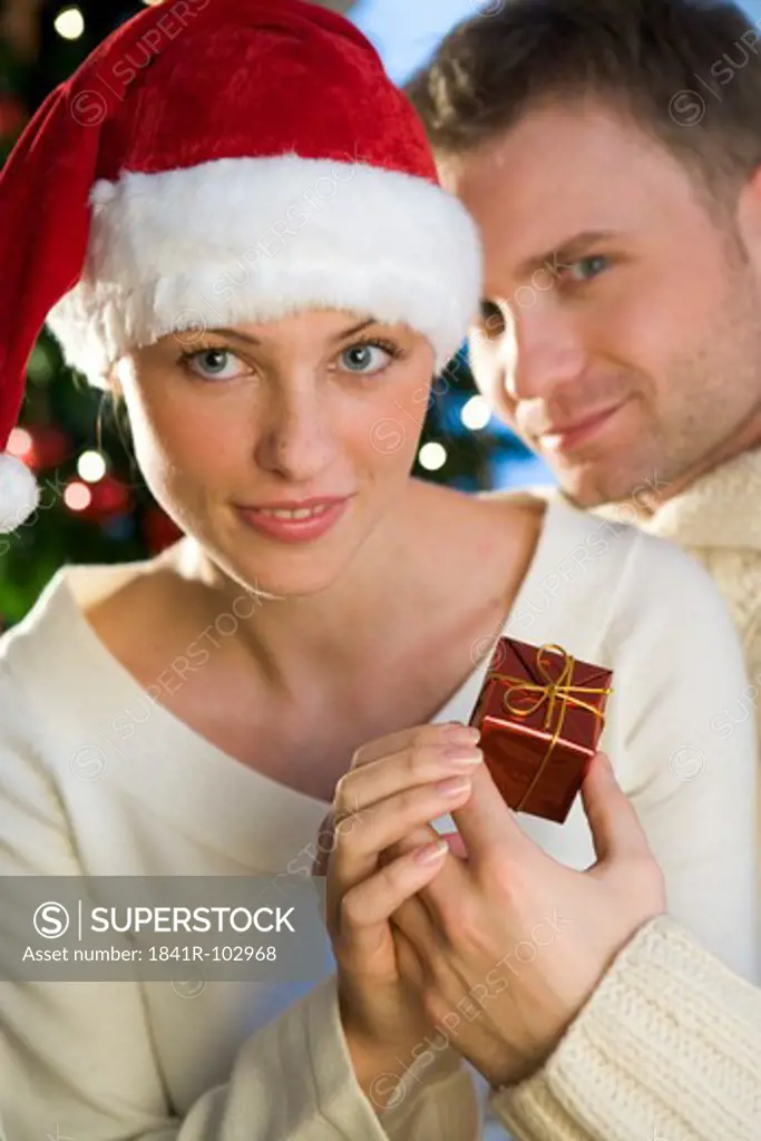 couple giving themself christmas presents