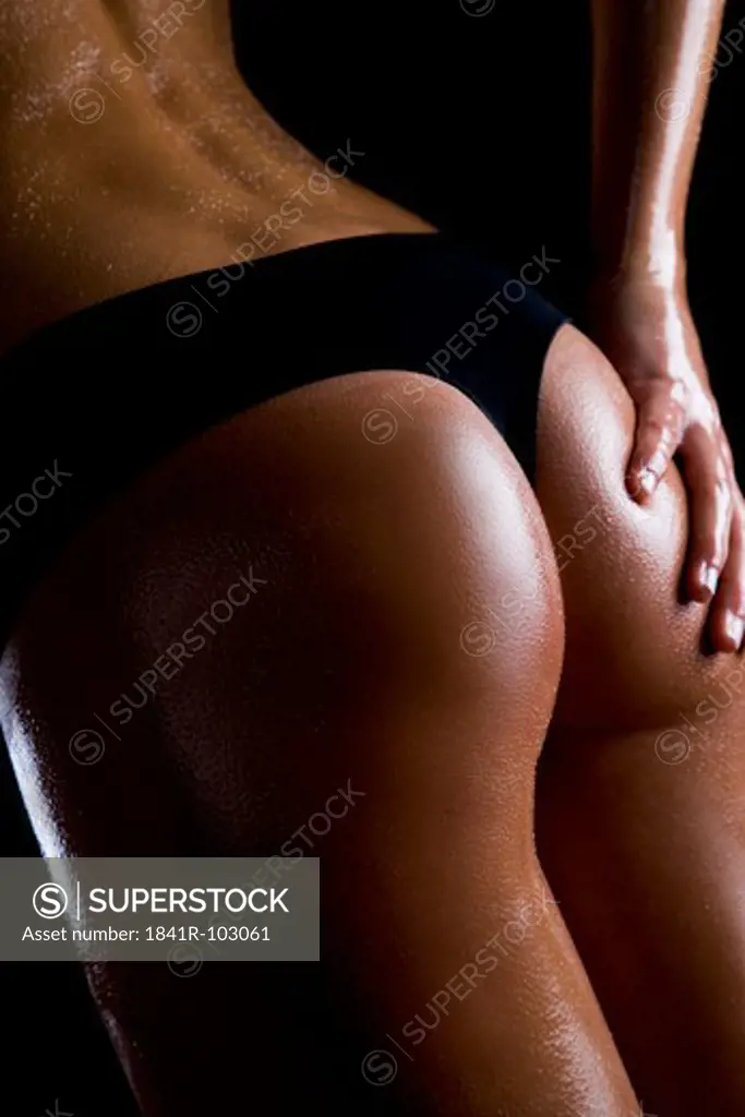woman applying oil on her bottom