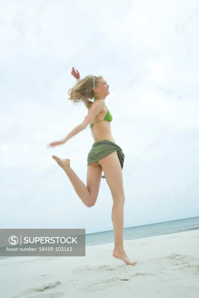 woman jumping on the beach