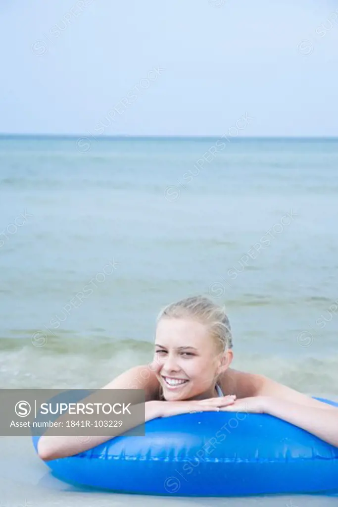 young woman with lifebelt in the sea