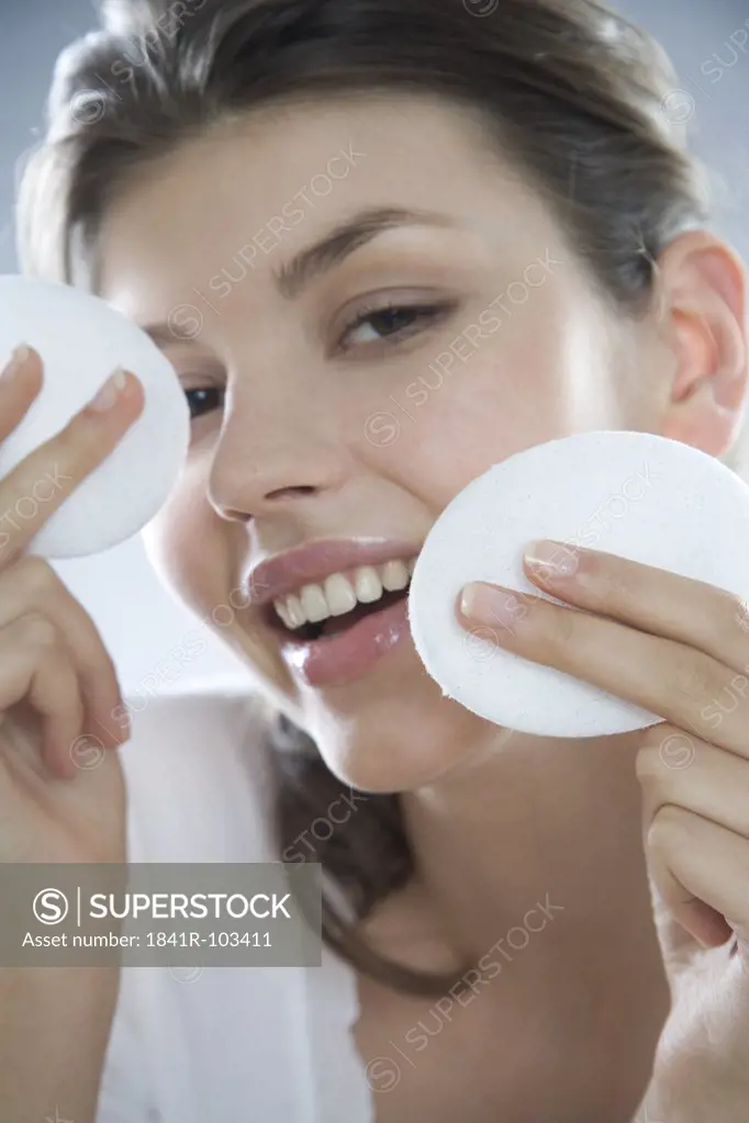 woman cleaning face