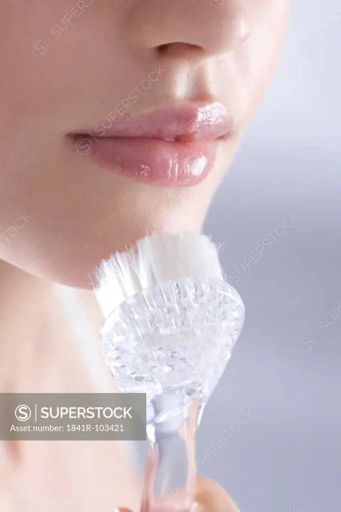 woman with face cleaning brush