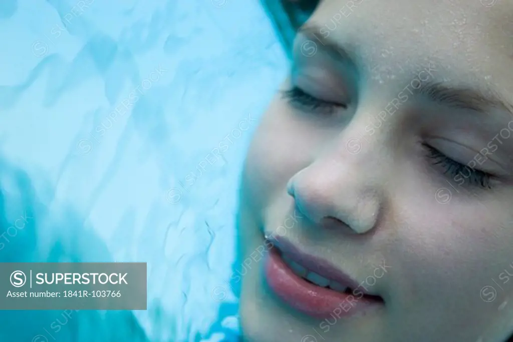 close-up of young woman in swimming pool