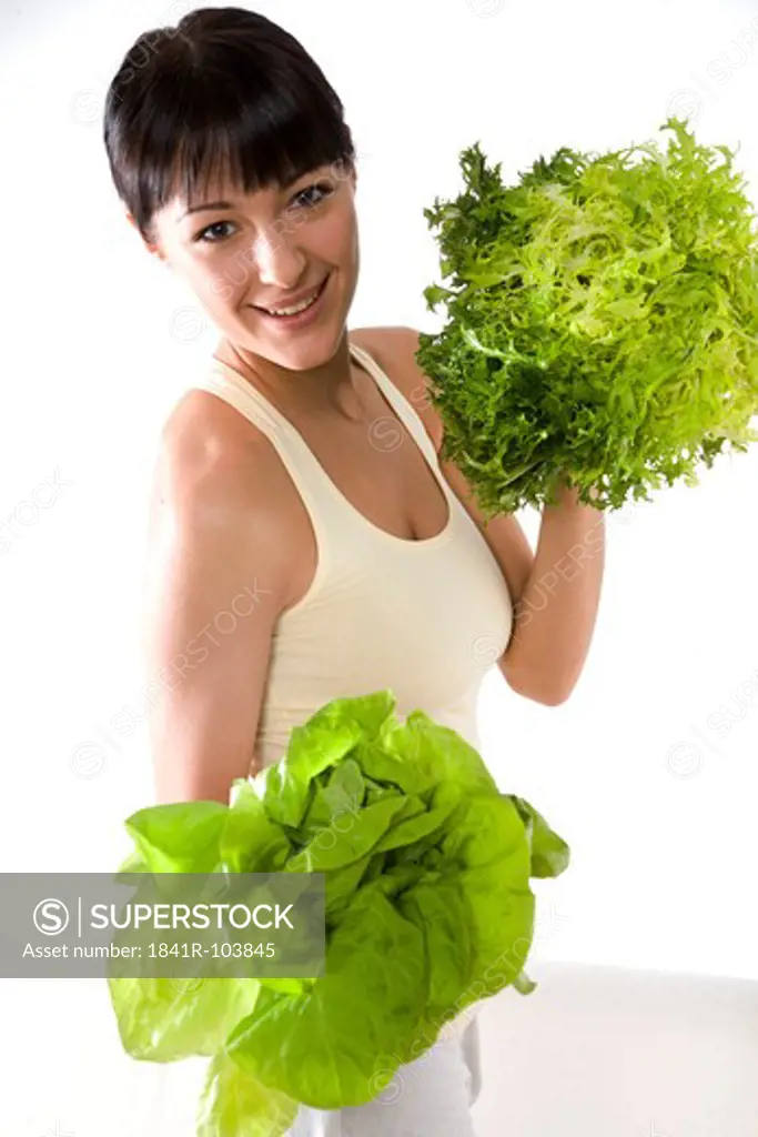 woman with two types of lettuce