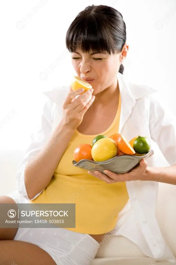 woman eating lemon