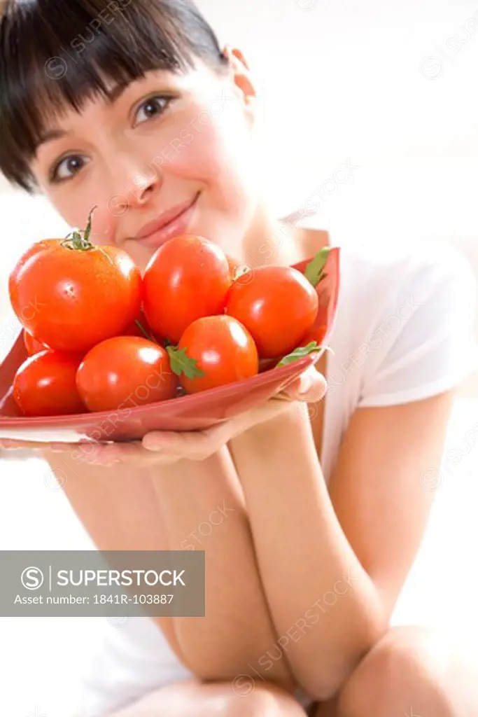woman holding tomatos