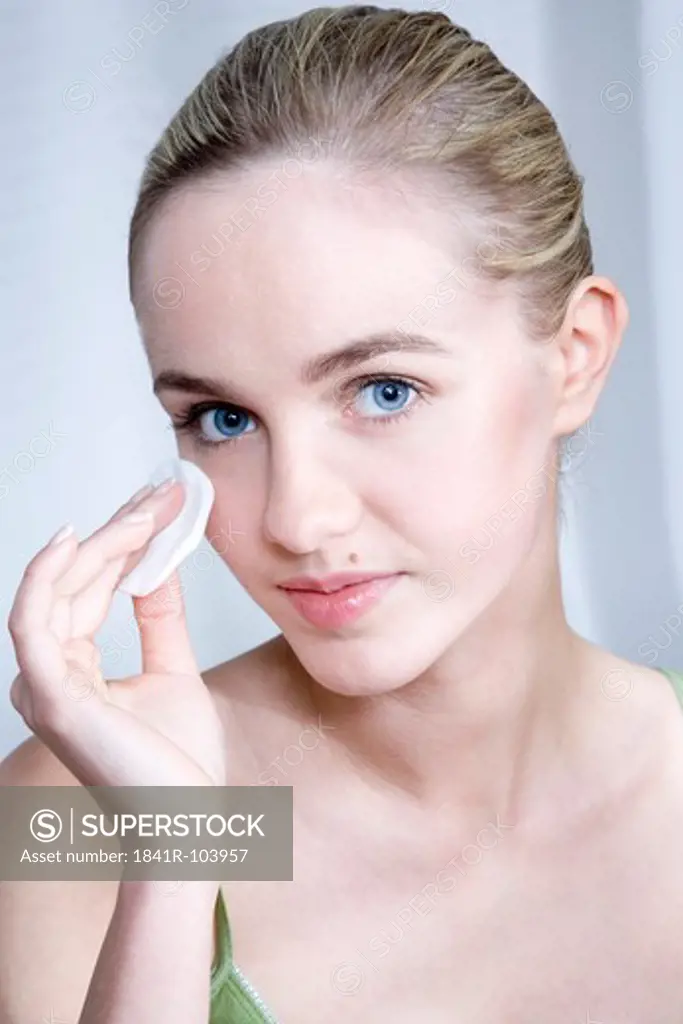 woman cleansing face