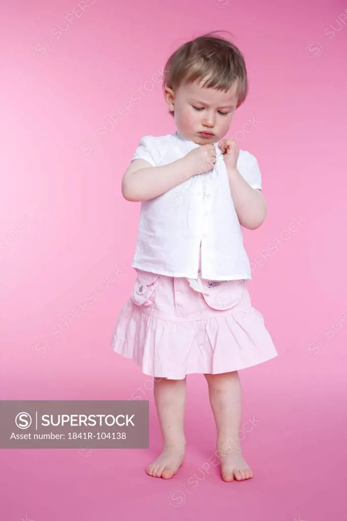 toddler girl putting up clothes