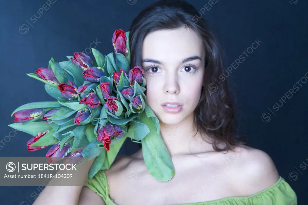 young woman with banch of tulips