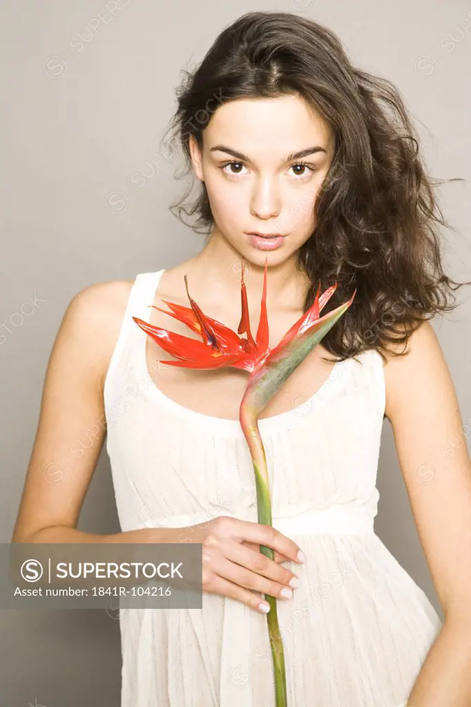 young woman with bird of paradise flower