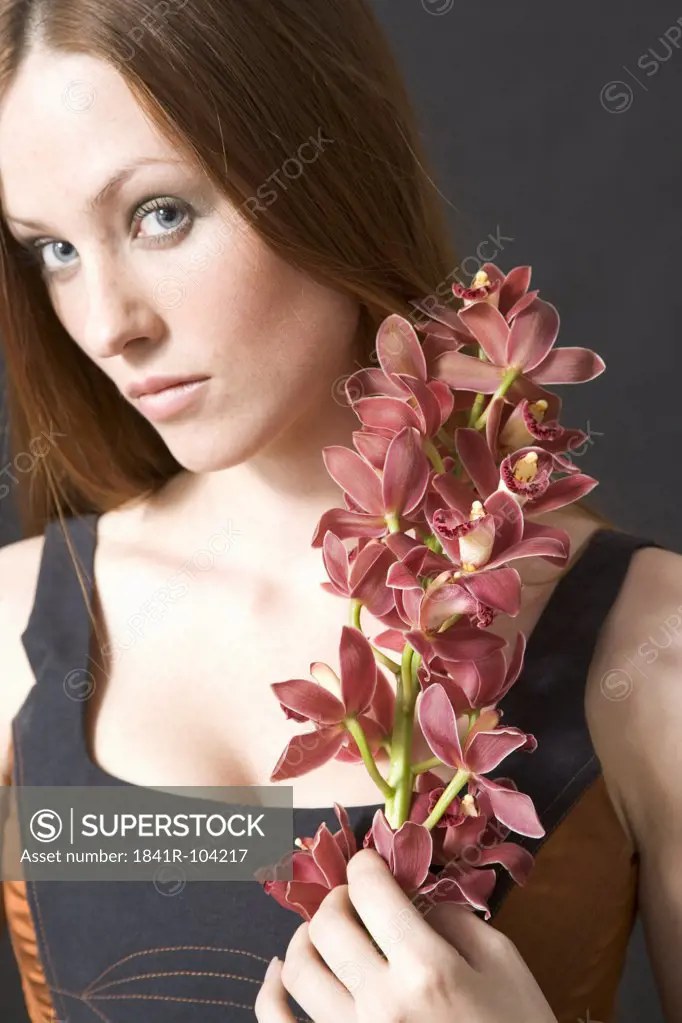 portrait of a woman with cymbidium orchids