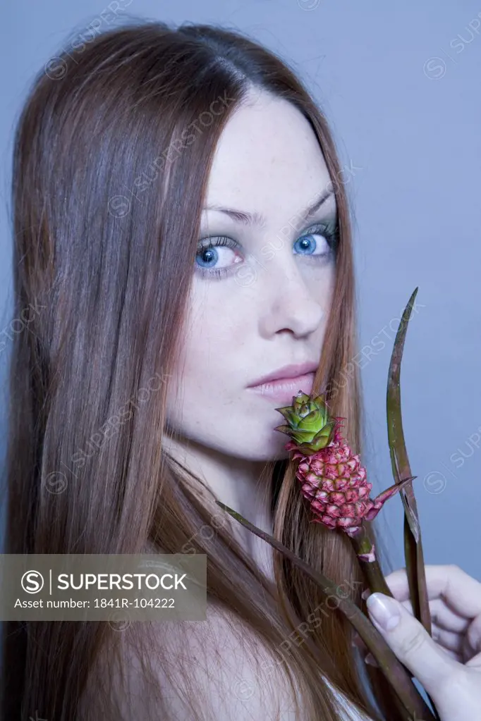 young woman with pineapple plant