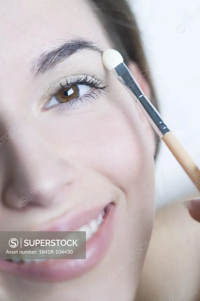 woman applying eye shadow