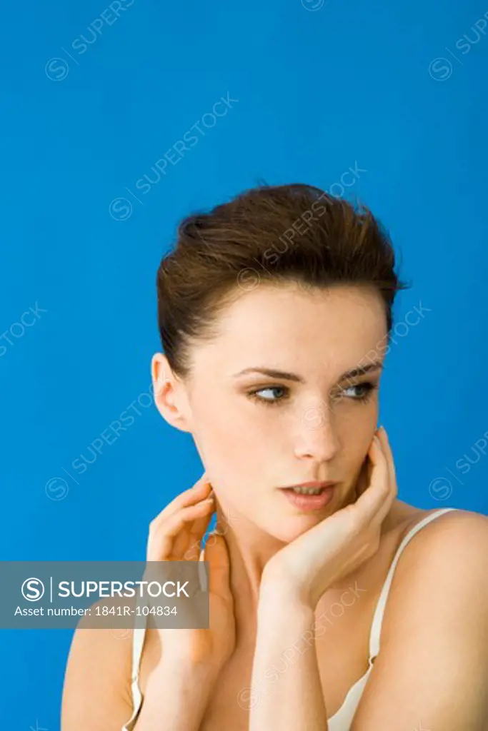 young woman touching her face