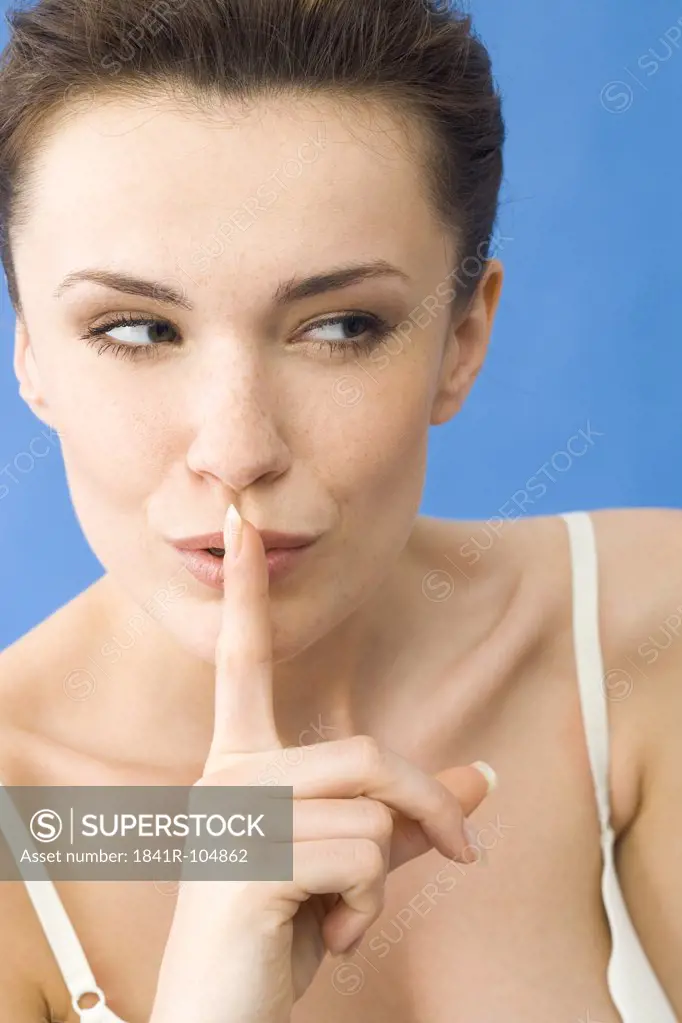 woman with finger on mouth