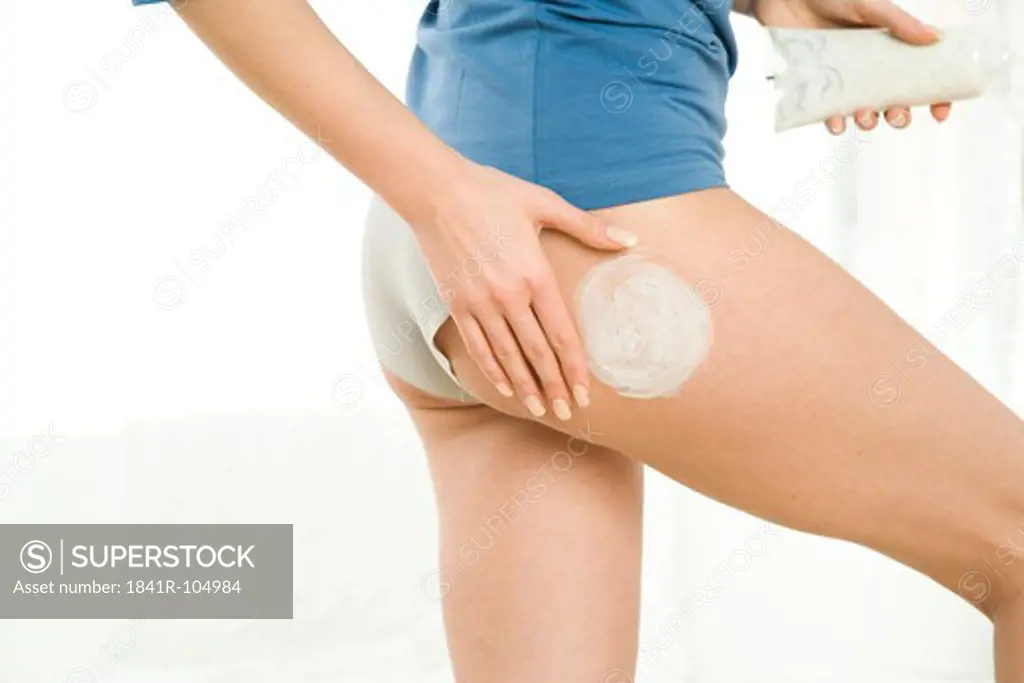 woman creaming legs
