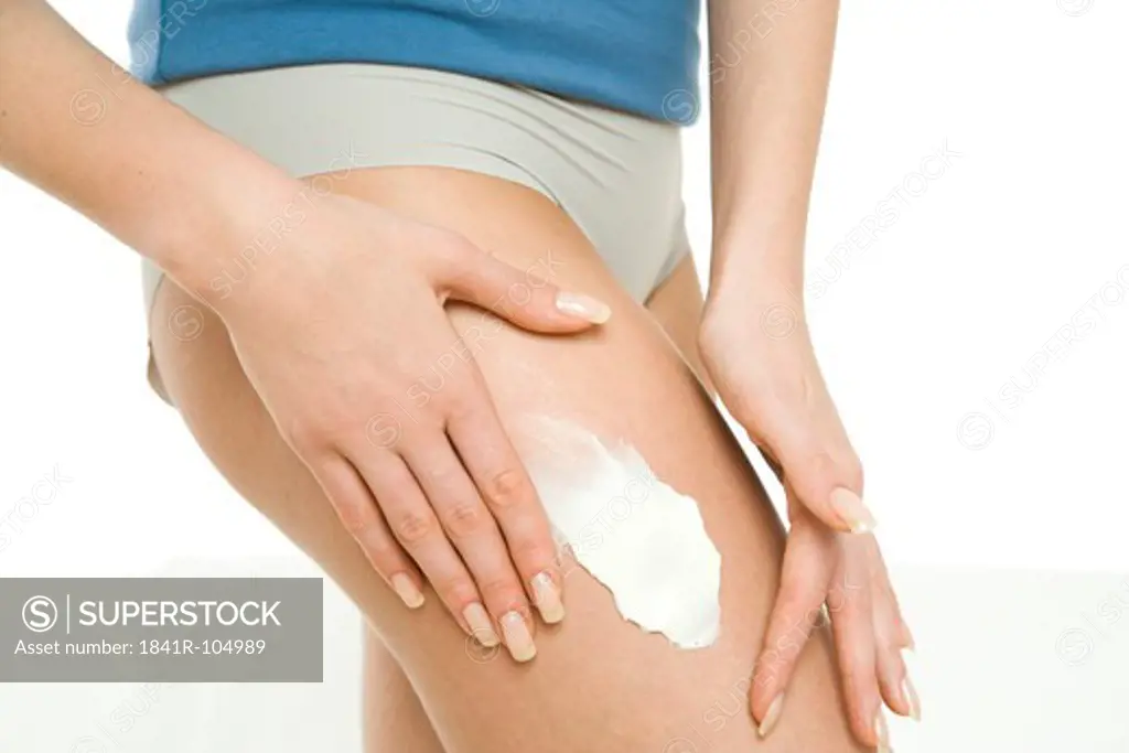 woman creaming legs