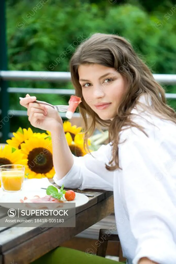 Woman eating on the terrace