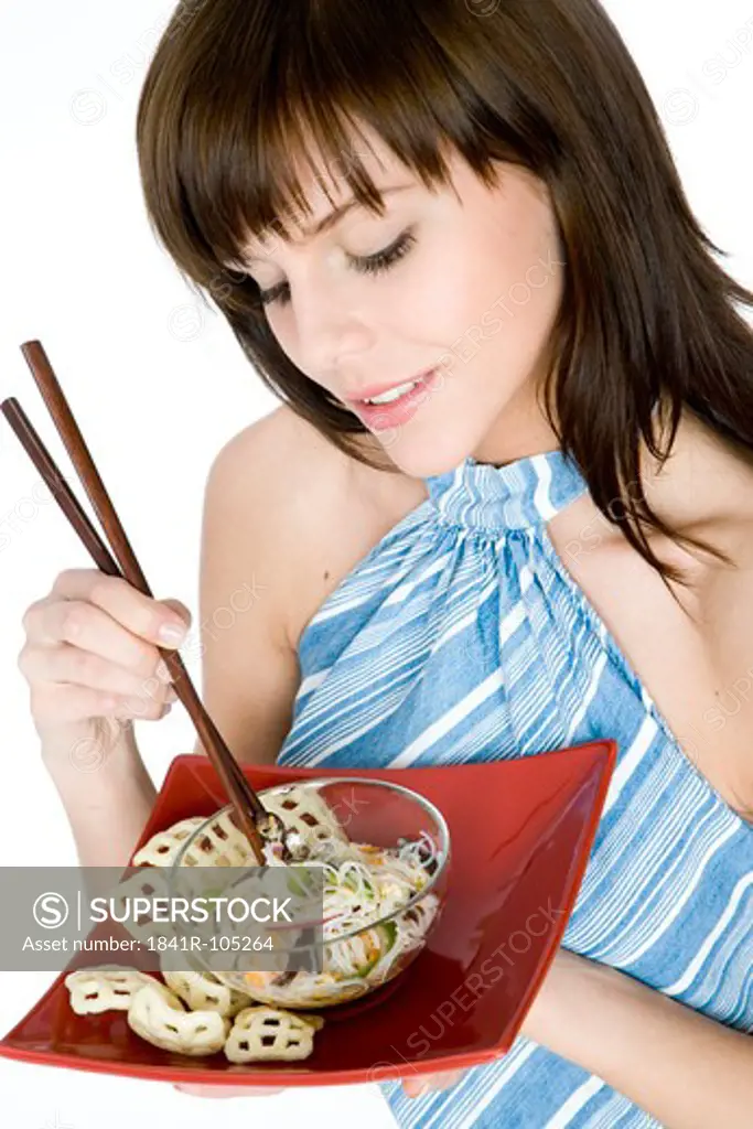 young woman eating asian noodles