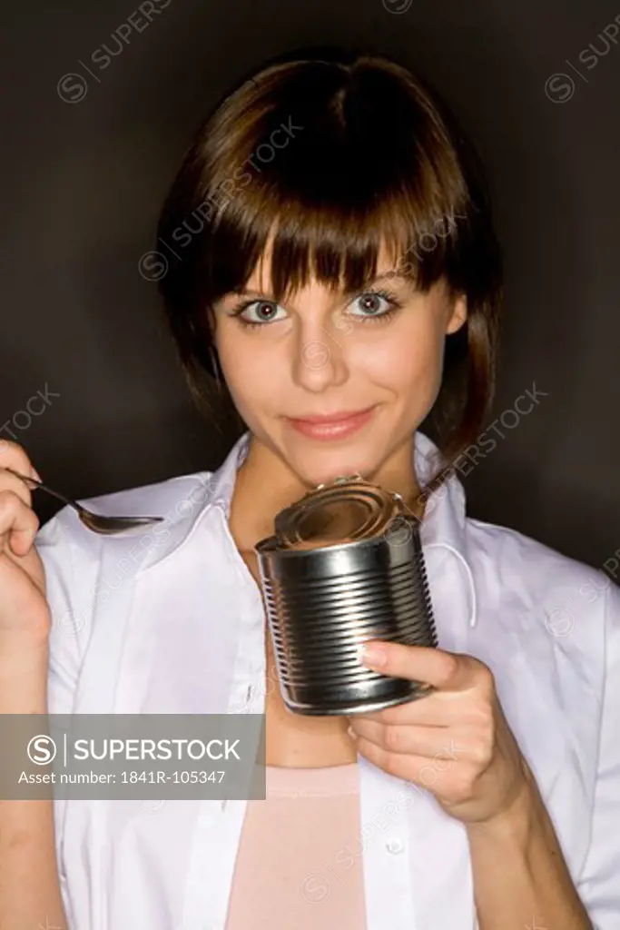 young woman eating from can