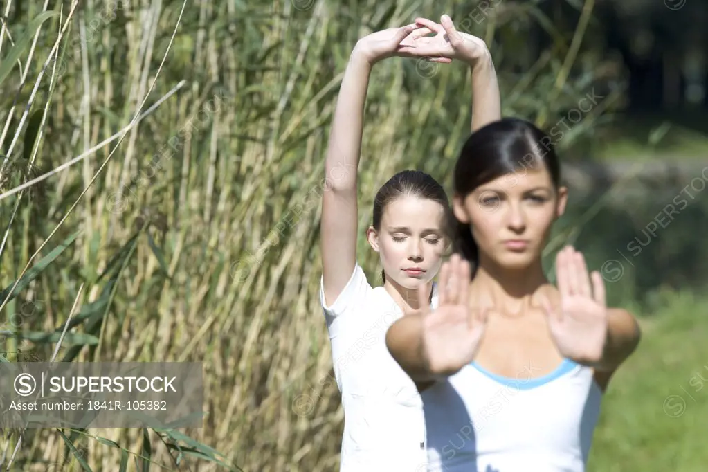 Young women exercising in park