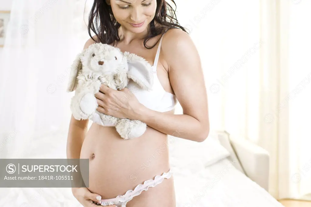 pregnant woman with teddy bear