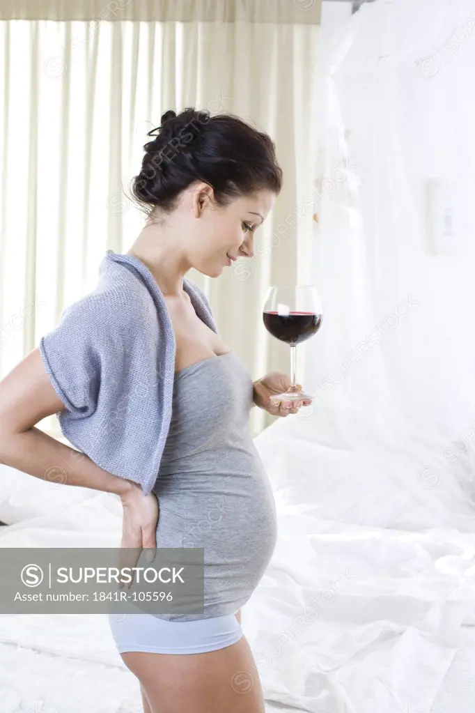 pregnant woman with glass of wine