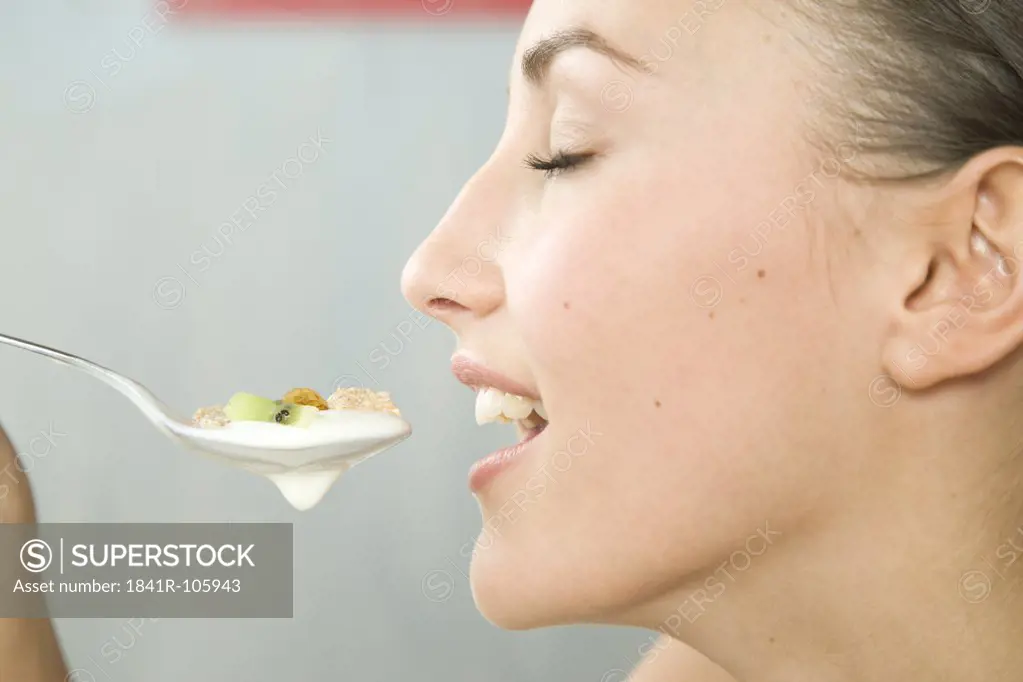 young woman eating muesli