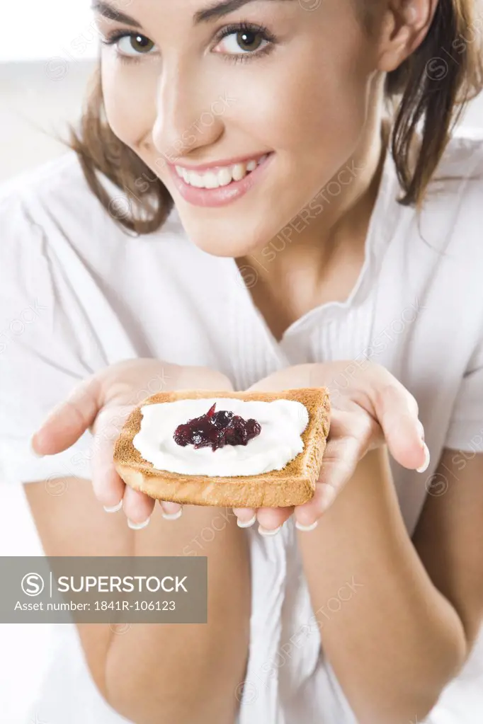 Woman eating toast with cottage cheese and jam