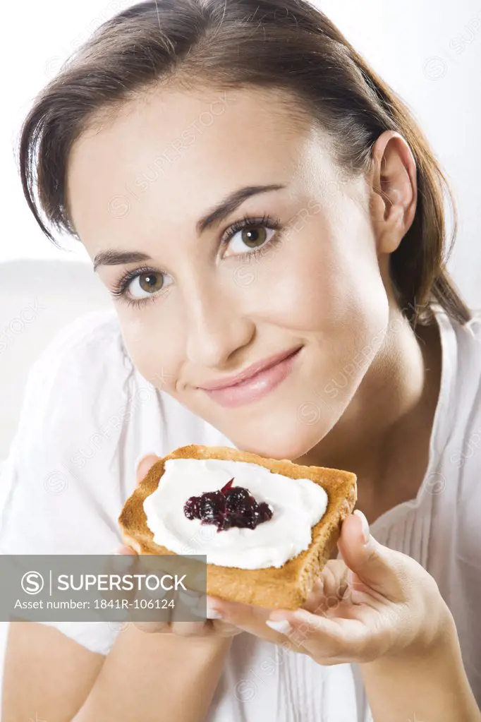 Woman eating toast with cottage cheese and jam