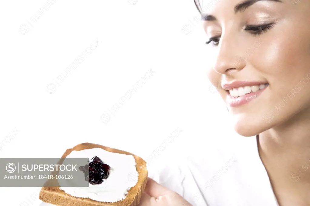 Woman eating toast with cottage cheese and jam