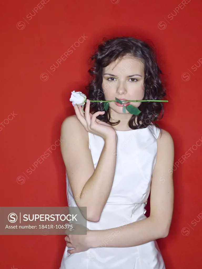 Young woman with white rose