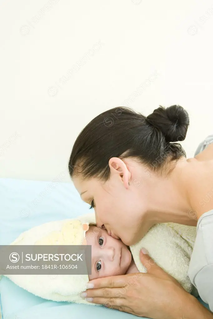 Mother kissing a baby