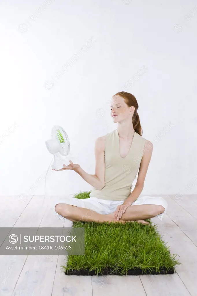 young woman holding fan