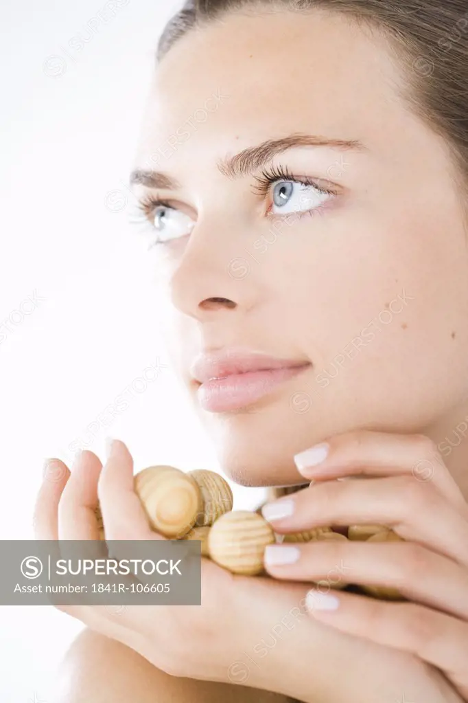 beauty woman with wodden balls on hand