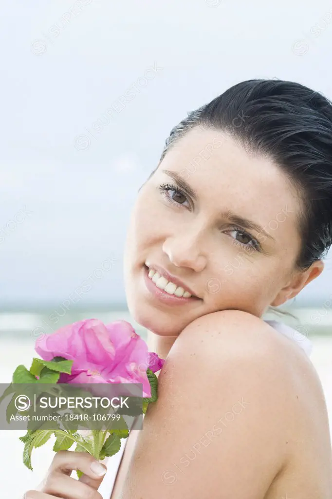 beauty woman with flower on beach