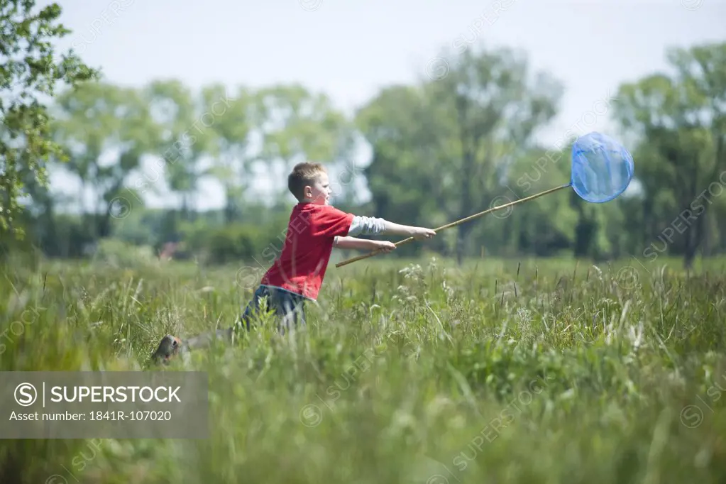 boy playing on meadow