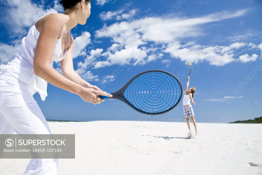 mother and daughter playing badminton