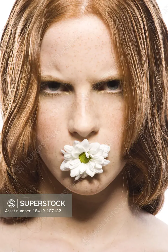 young woman with flower in mouth