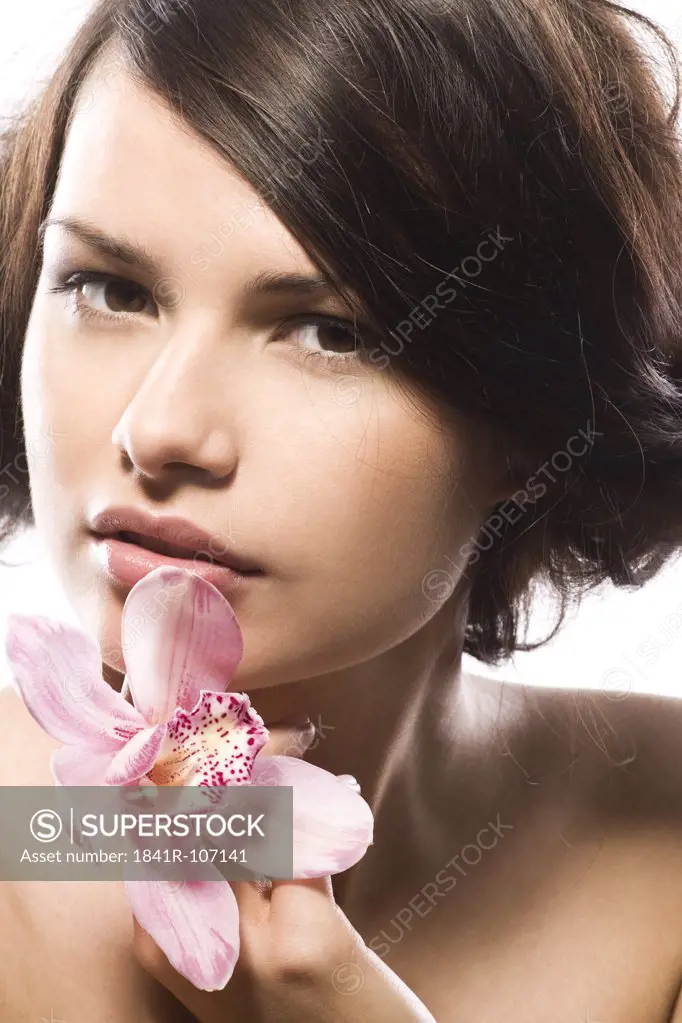 young woman with pink orchid