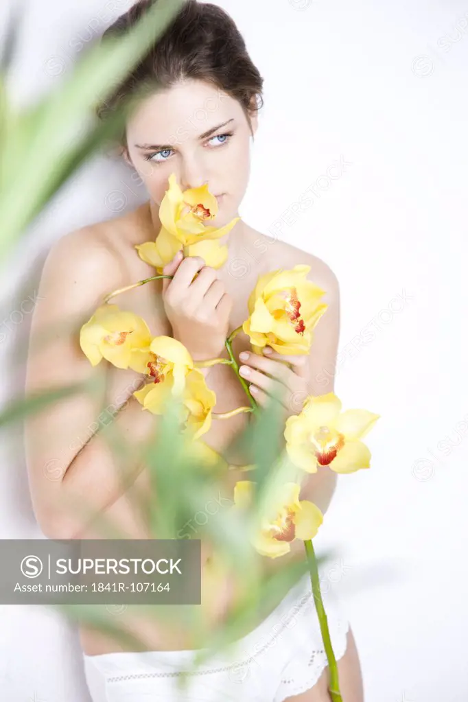 nude woman with yellow orchid