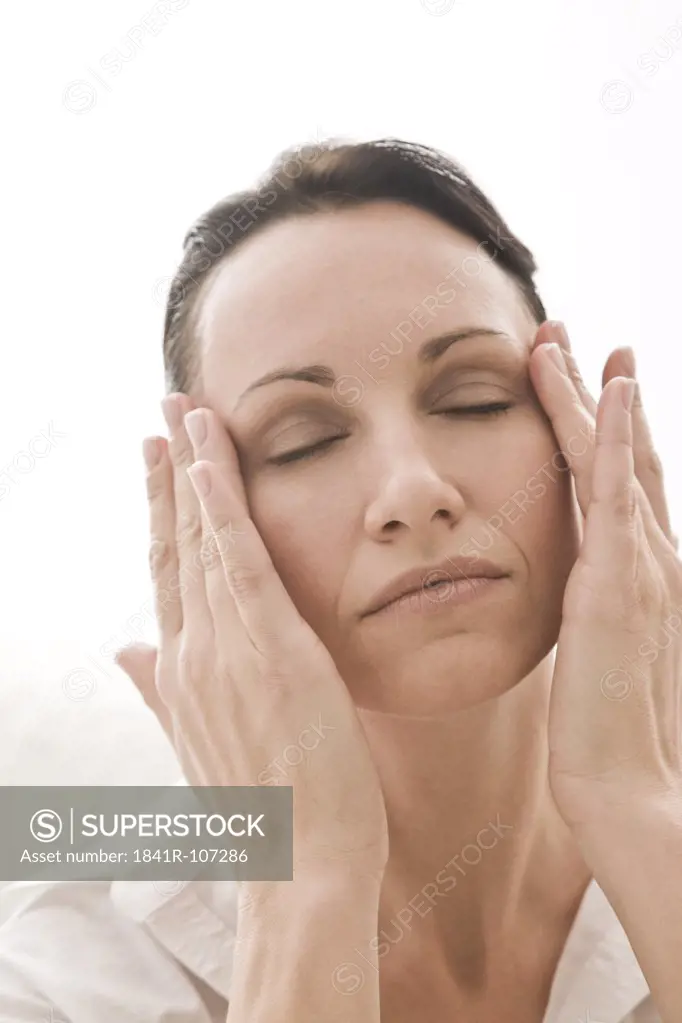 woman massaging face