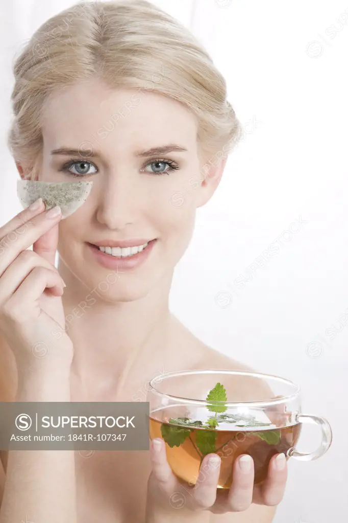 woman with teabags under eye