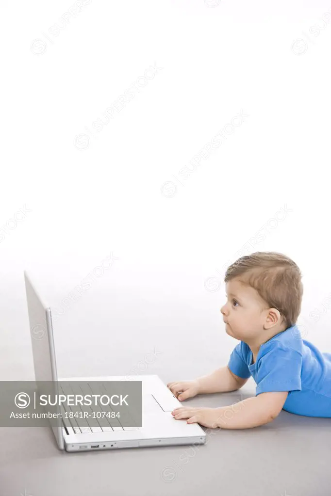 Baby on floor with laptop